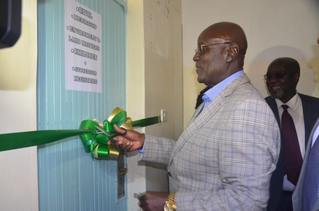 Court of Appeal Judge, Aggrey Muchelule cuts a ribbon to mark the launching of Nyahururu Court Annexed Mediation, by Antony Mwangi.
