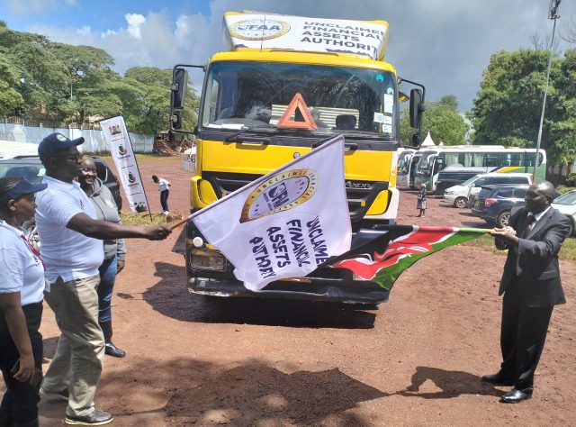 UFAA CEO John Mwangi (left) and Murang’a East Deputy County Commissioner Thomas Nyoro flag off a truck for a roadshow campaign on services offered by the authority. Photo by Bernard Munyao
