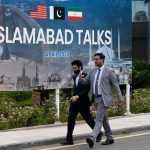 People walk past the press center for the talks between the United States and Iran in Islamabad, Pakistan, April 11, 2026. (Xinhua/Wang Shen)
