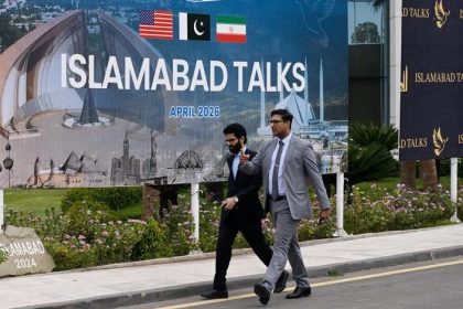People walk past the press center for the talks between the United States and Iran in Islamabad, Pakistan, April 11, 2026. (Xinhua/Wang Shen)