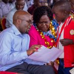 PS Interior Dr. Raymond Omollo and Homabay Governor Gladys Wanga attending to a boy.