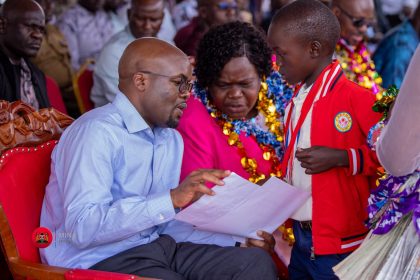 PS Interior Dr. Raymond Omollo and Homabay Governor Gladys Wanga attending to a boy.