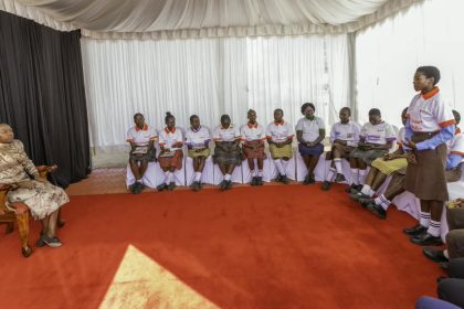 First Lady Rachel Ruto (left) listening to girls